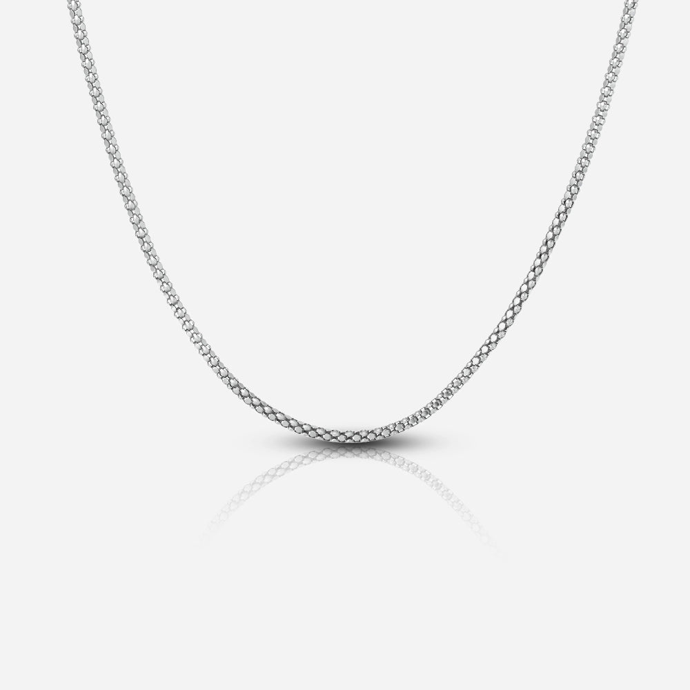 Silver crub chain necklace on a light gray background