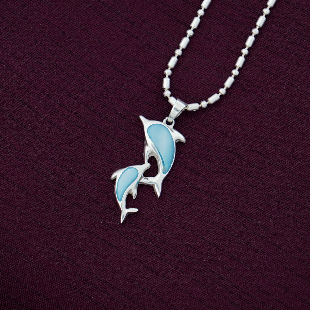 Silver necklace with a blue pendant on a dark purple background