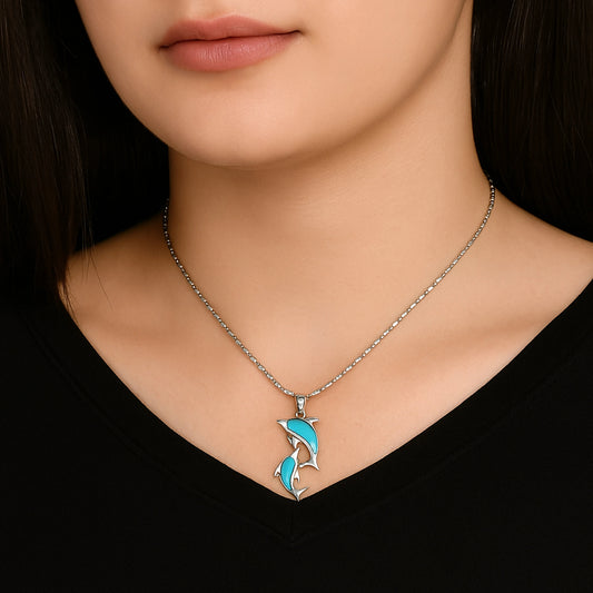 Necklace with a turquoise pendant worn by a person against a black background