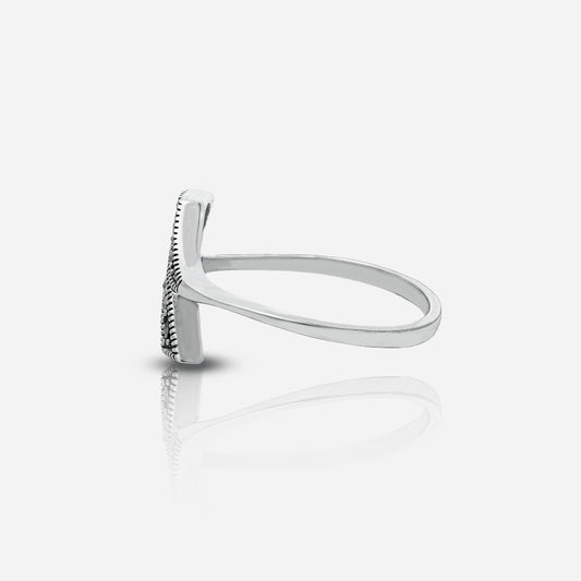 Silver ring with a textured band on a white background