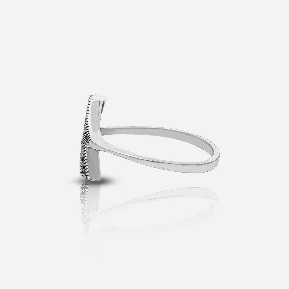 Silver ring with a textured band on a white background