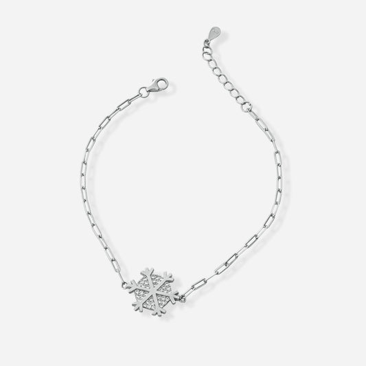 Silver cross bracelet with a snowflake charm on a white background